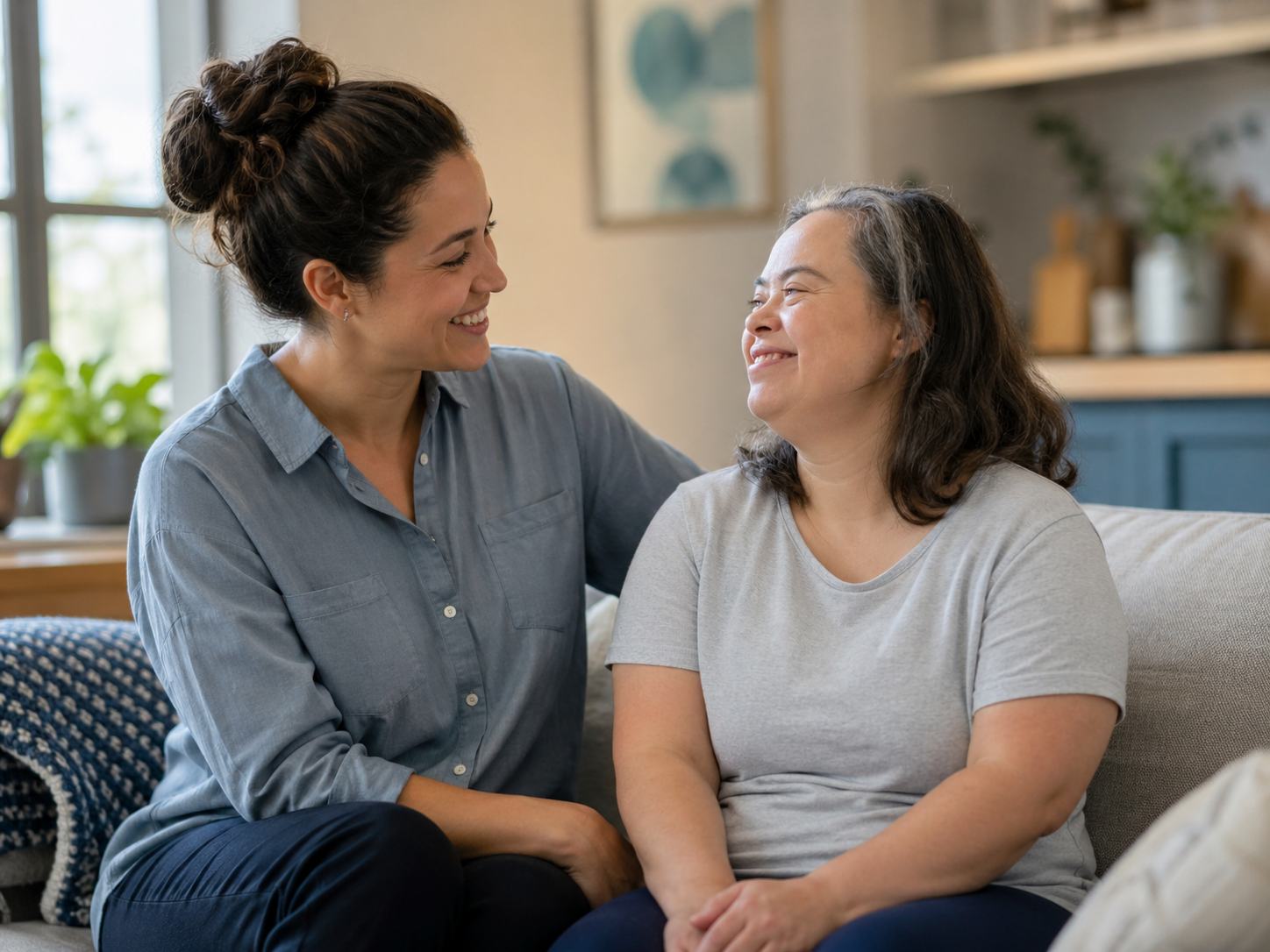 A support professional and a supported person sharing a warm moment.